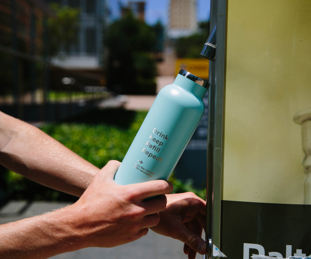 Student filling reusable water bottle