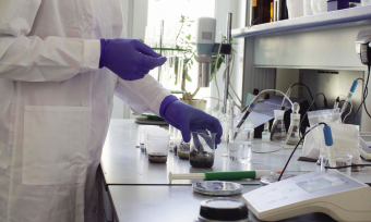 Person conducting soil experiments in lab