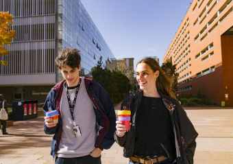 one woman and one man drinking coffee in reusable cup