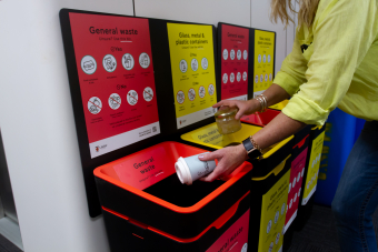 staff putting waste into bin