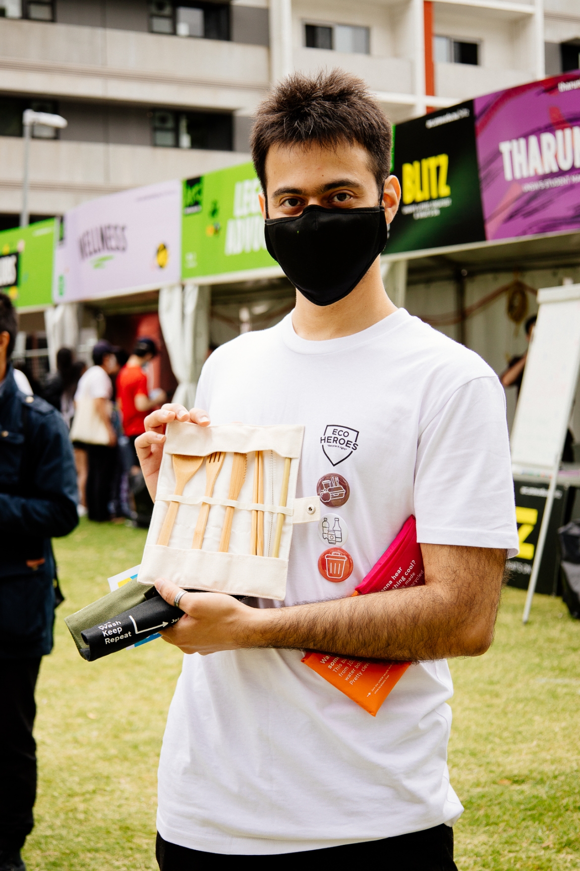 Photograph of student volunteer holding up UNSW Plastic Free reusable cutlery