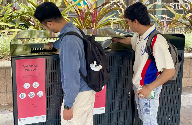 student disposing waste in bins