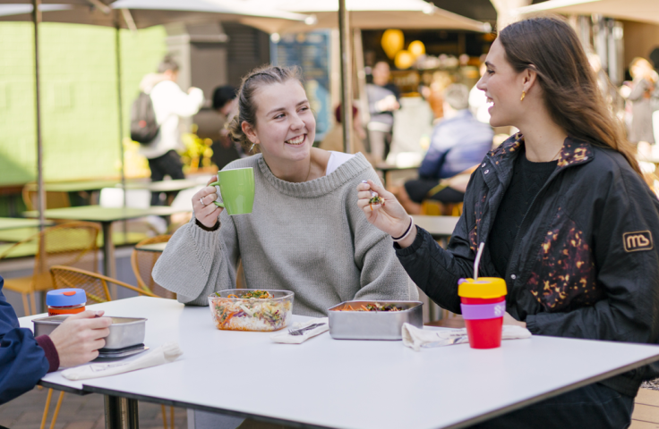 students drinking coffee and eating in reusable container